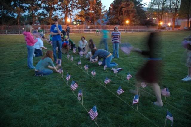 Various UNO College Democrats place flags early in the night