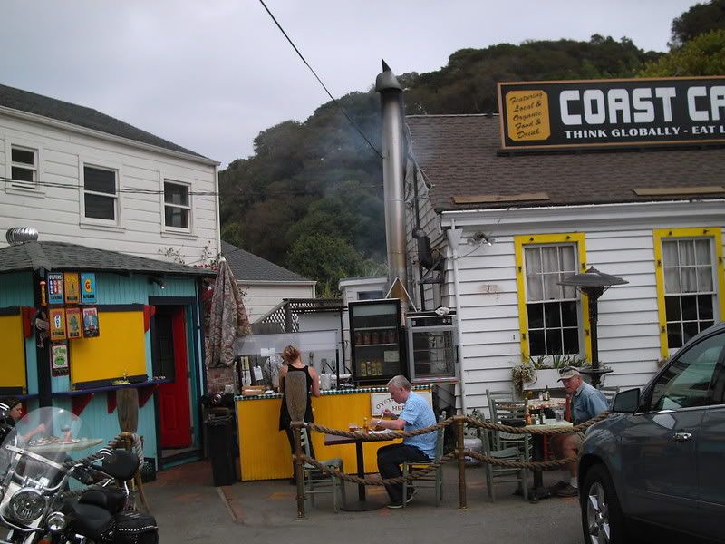 the sign says 'think global eat local' at the Coast Cafe