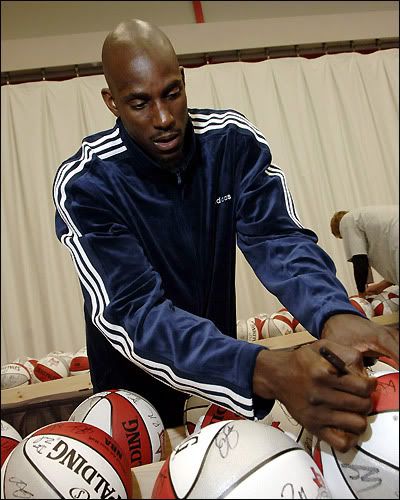 KG signs some basketballs on Saturday